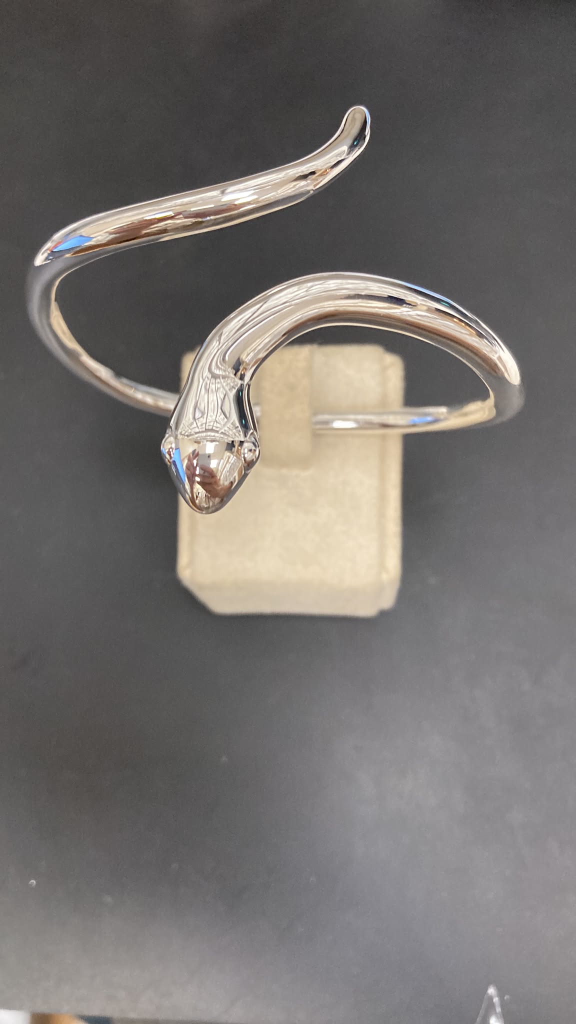 Sterling silver snake bangle with a sleek design, featuring a snake head centerpiece, oval shape 50x65mm.