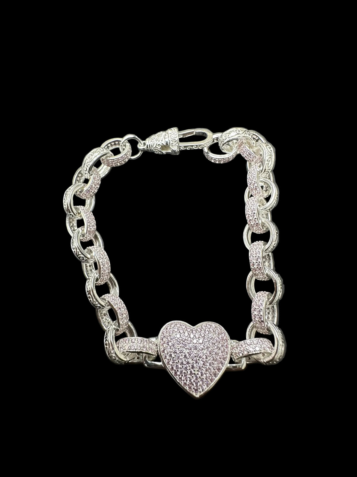 Sterling silver heart bracelet featuring a pink CZ pattern with a heart charm on a belcher chain.