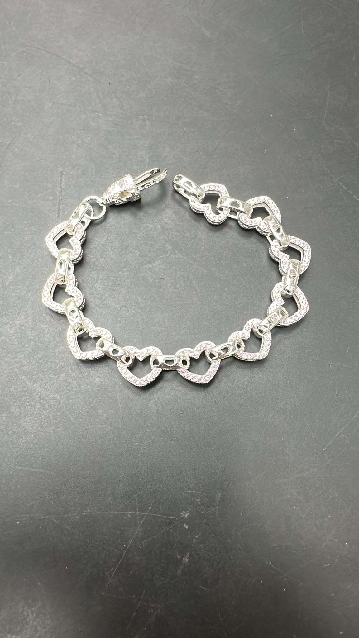 Sterling silver open heart bracelet with pink accents and heart-shaped links, 10MM and 8MM sizes.