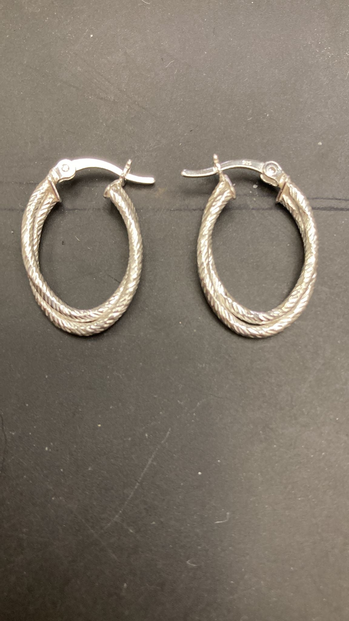 Sterling silver rope twist hoop earrings EP10205 displayed on a black background.