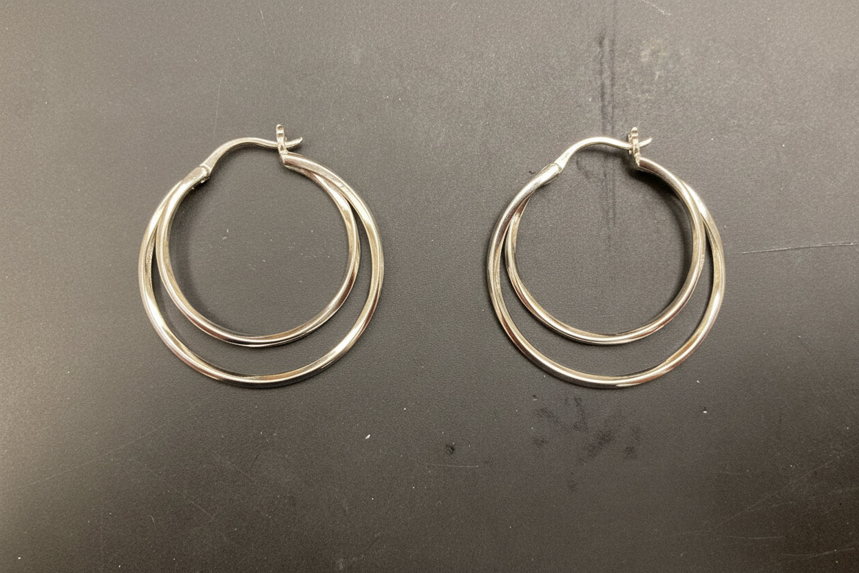 Sterling silver double wire hoop earrings EP701 displayed from the front on a dark surface.