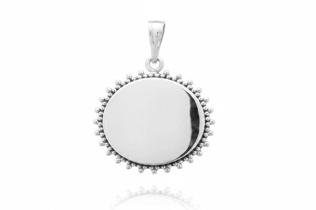 Sterling silver sun pendant with a shiny, plain surface and sunray design, 20 mm in size.