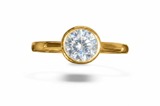 Sterling silver round rubover ring with a 6mm CZ stone, gold plated, elegant design for stylish occasions.