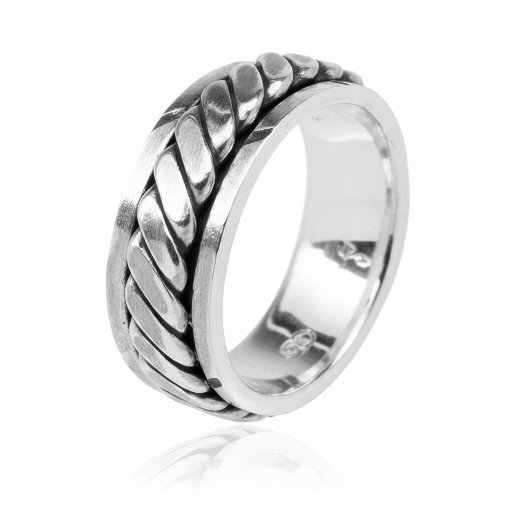 6mm sterling silver spinner ring with braided design, reflecting light elegantly.