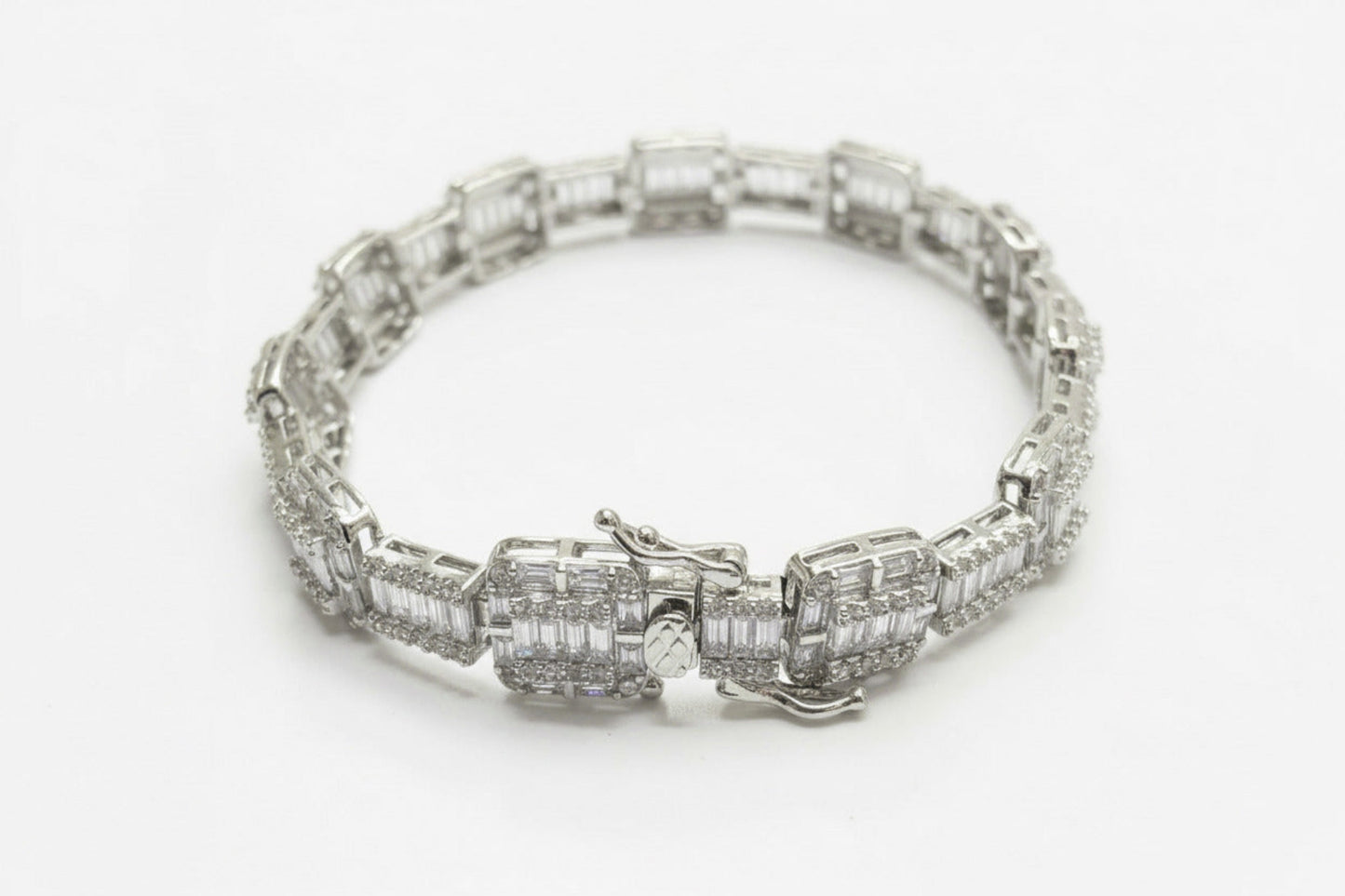 Silver bracelet with diamond accents on a dark gray background