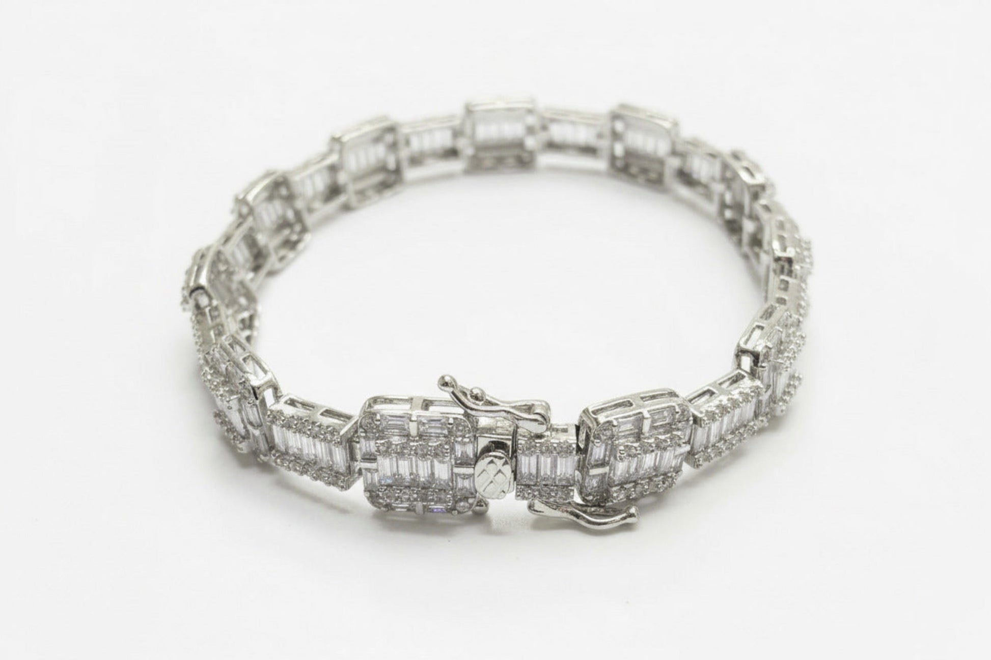 Silver bracelet with diamond accents on a dark gray background