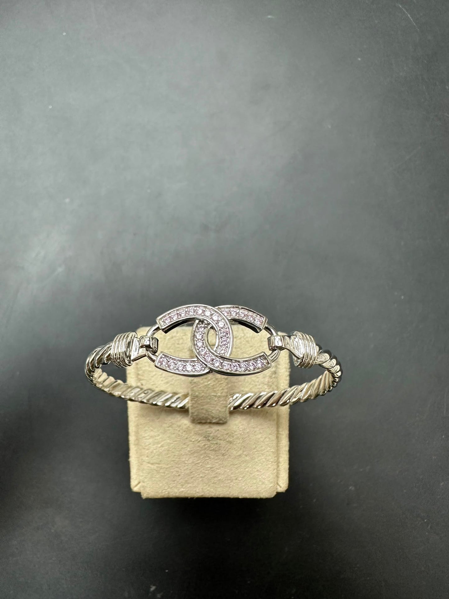 Sterling silver horse shoe bangle featuring pink CZ stones, elegant design, 4mm width.