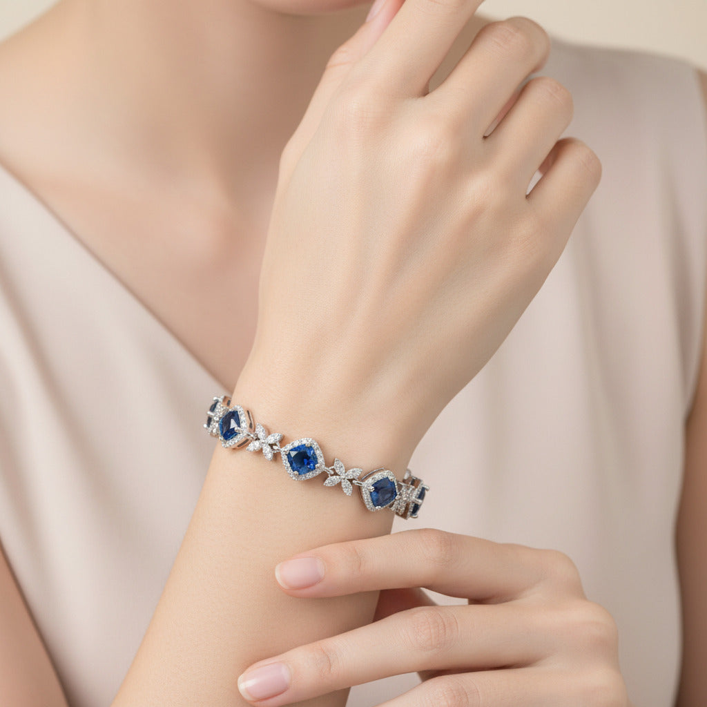Silver bracelet with BLUE gemstones on a white background