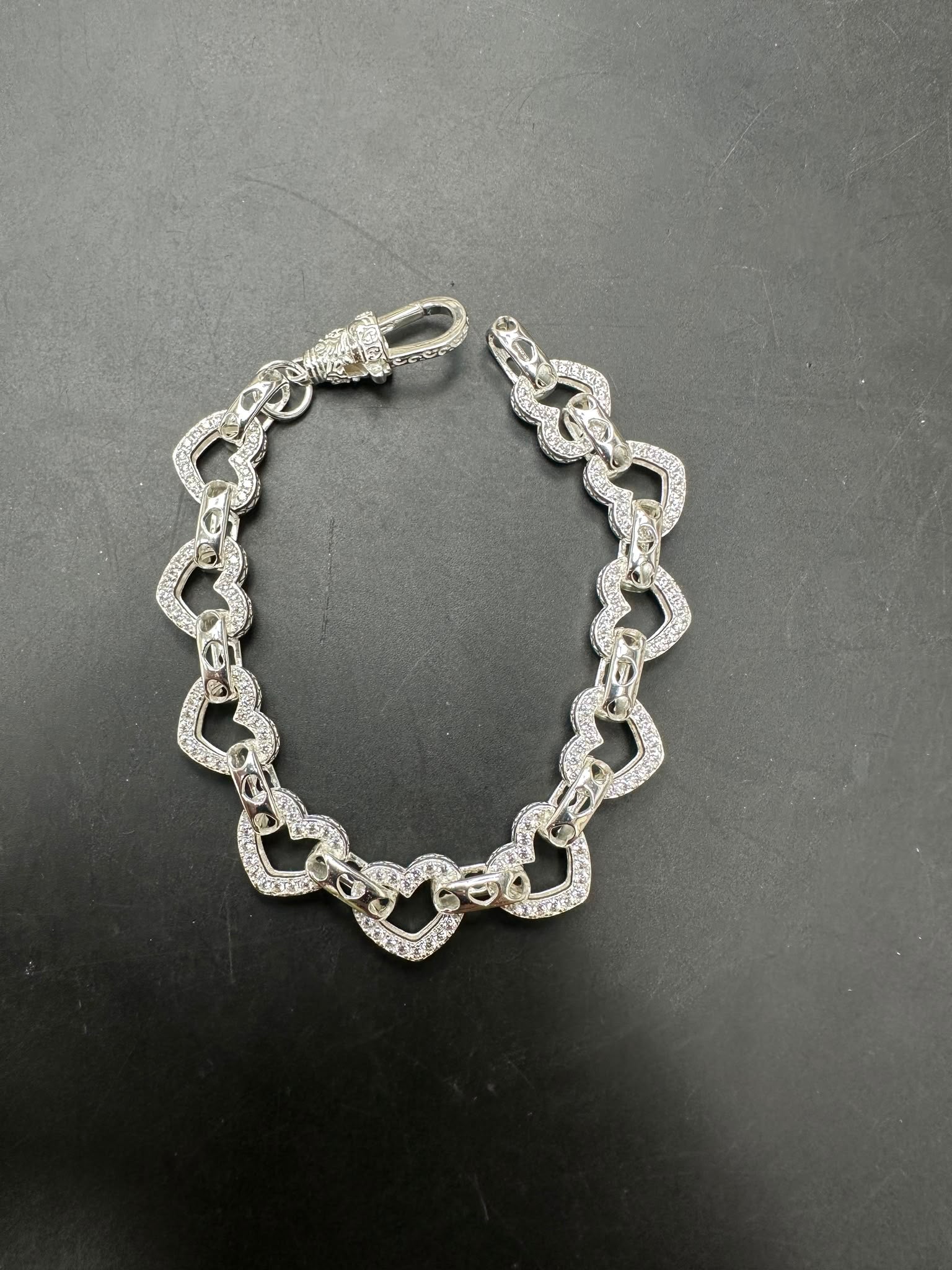 Sterling silver open heart bracelet, large 10mm, small 8mm, showcasing elegant white heart designs.