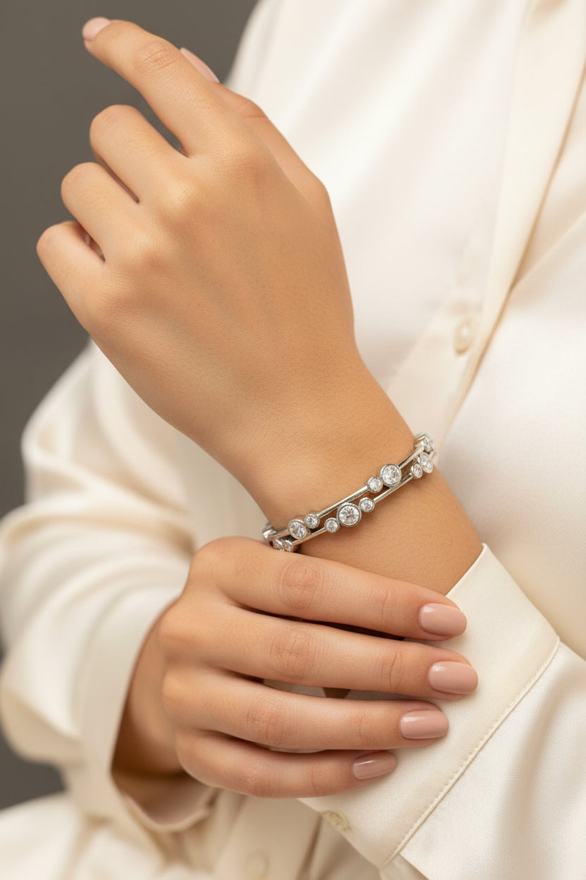 Silver bracelet with diamonds in a black box on a gray surface