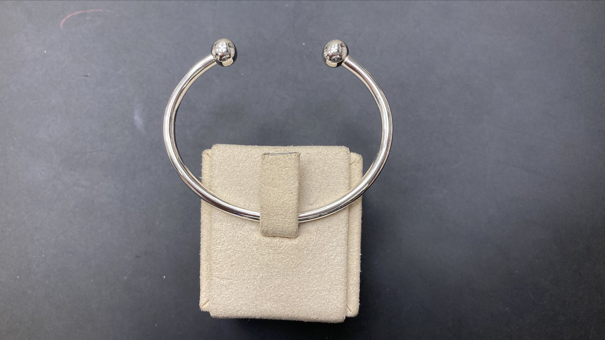 Sterling silver children's torque bangle BPL10104 displayed on a soft pouch, showcasing its 3MM thickness and stylish design.