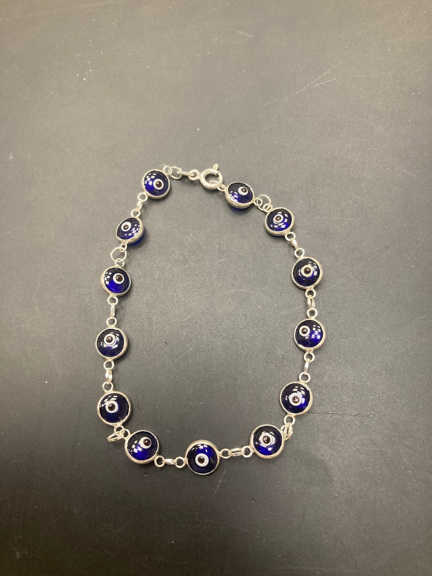 Sterling Silver Evil Eye Bracelet BR001 featuring blue and silver eye charms on a chain.