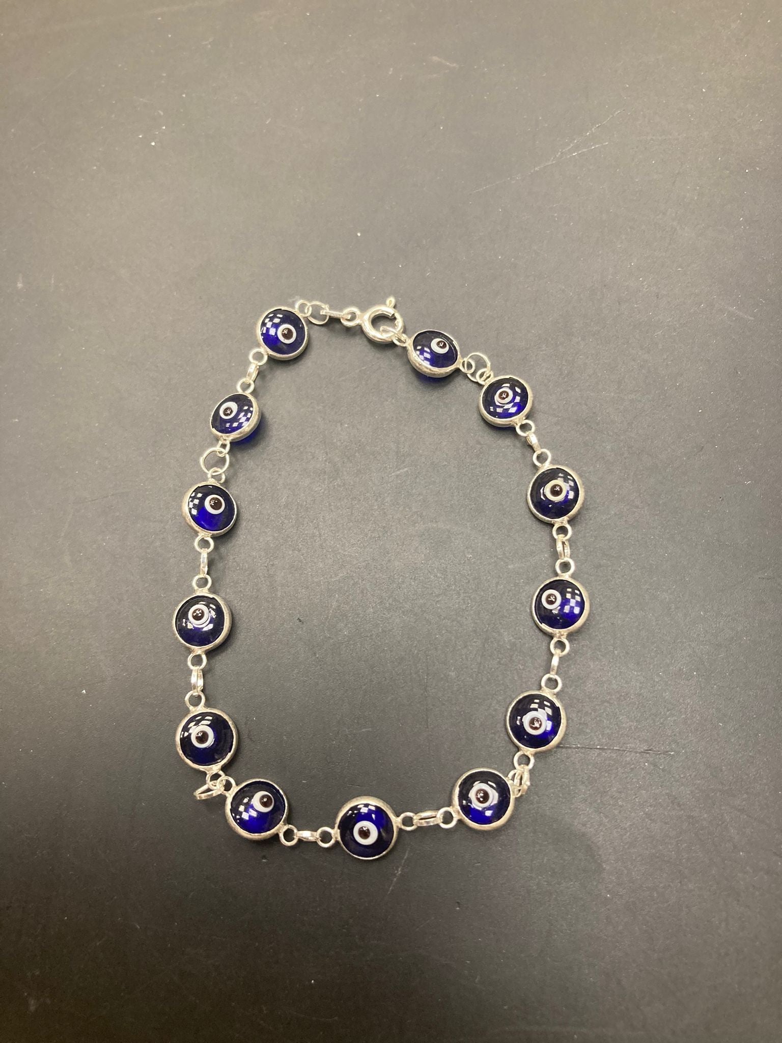Sterling Silver Evil Eye Bracelet BR001 featuring blue and silver eye charms on a chain.