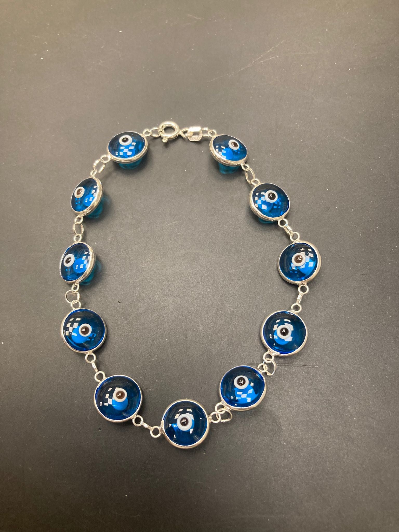 Sterling Silver Evil Eye Bracelet BR001 featuring blue glass evil eye charms on a silver chain.