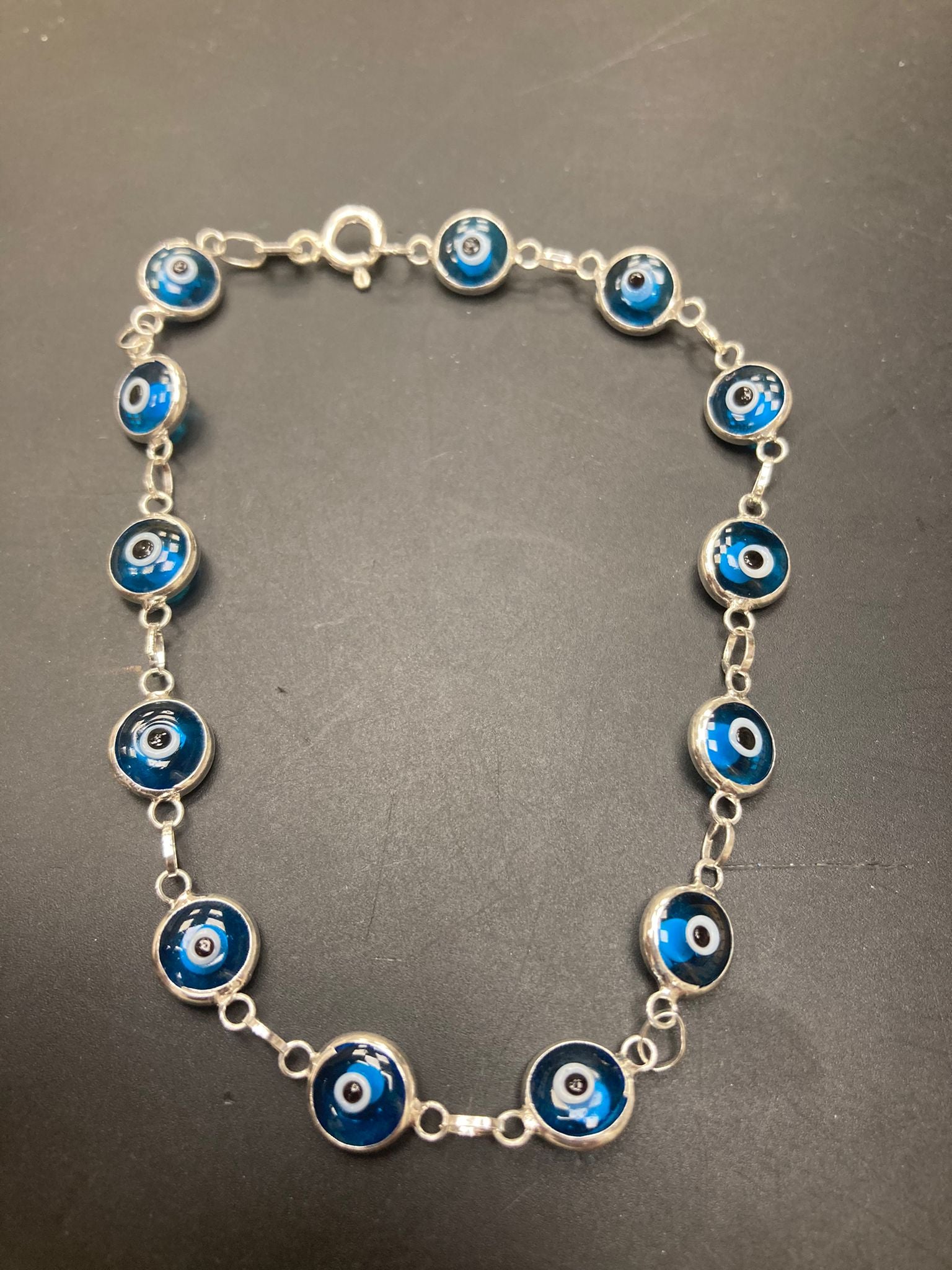Sterling Silver Evil Eye Bracelet BR001 featuring blue evil eye charms linked with sterling silver chain.