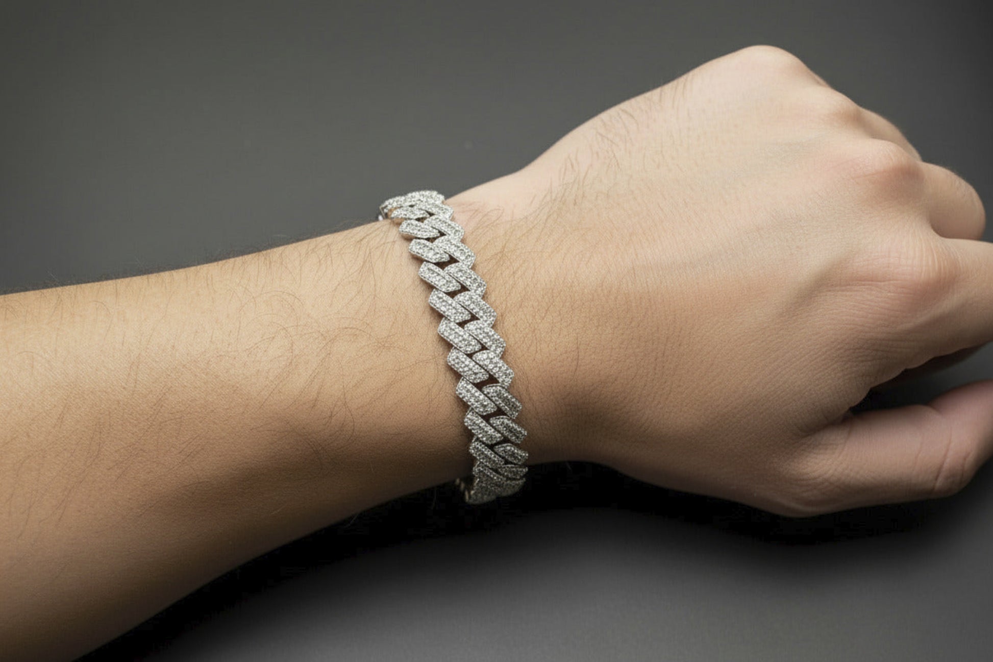 Silver chain bracelet on a dark gray background
