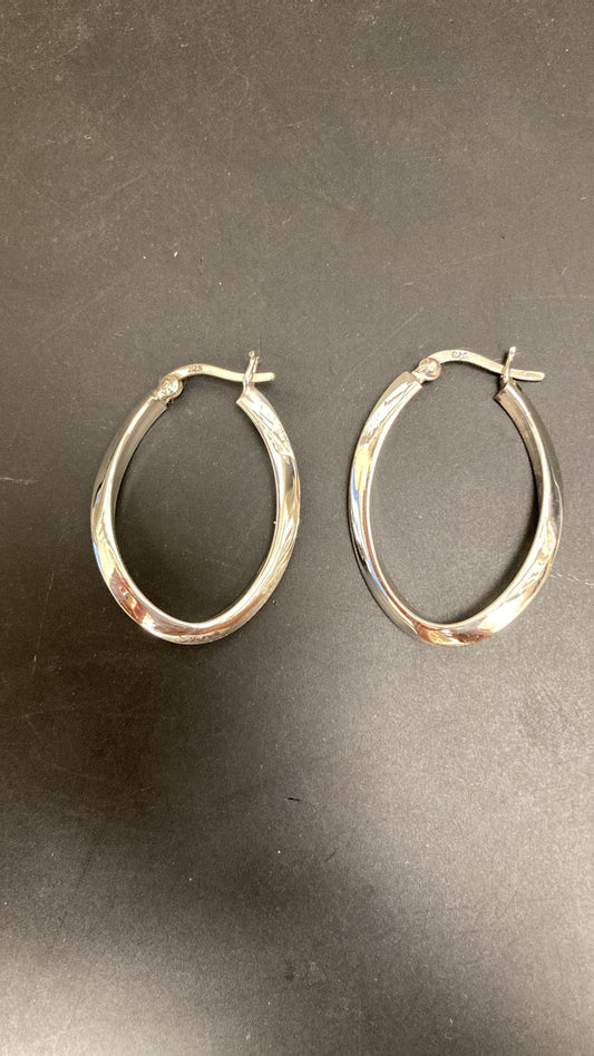 Sterling silver hoop earrings featuring a twist design in an oval shape, perfect for elegant or casual wear.