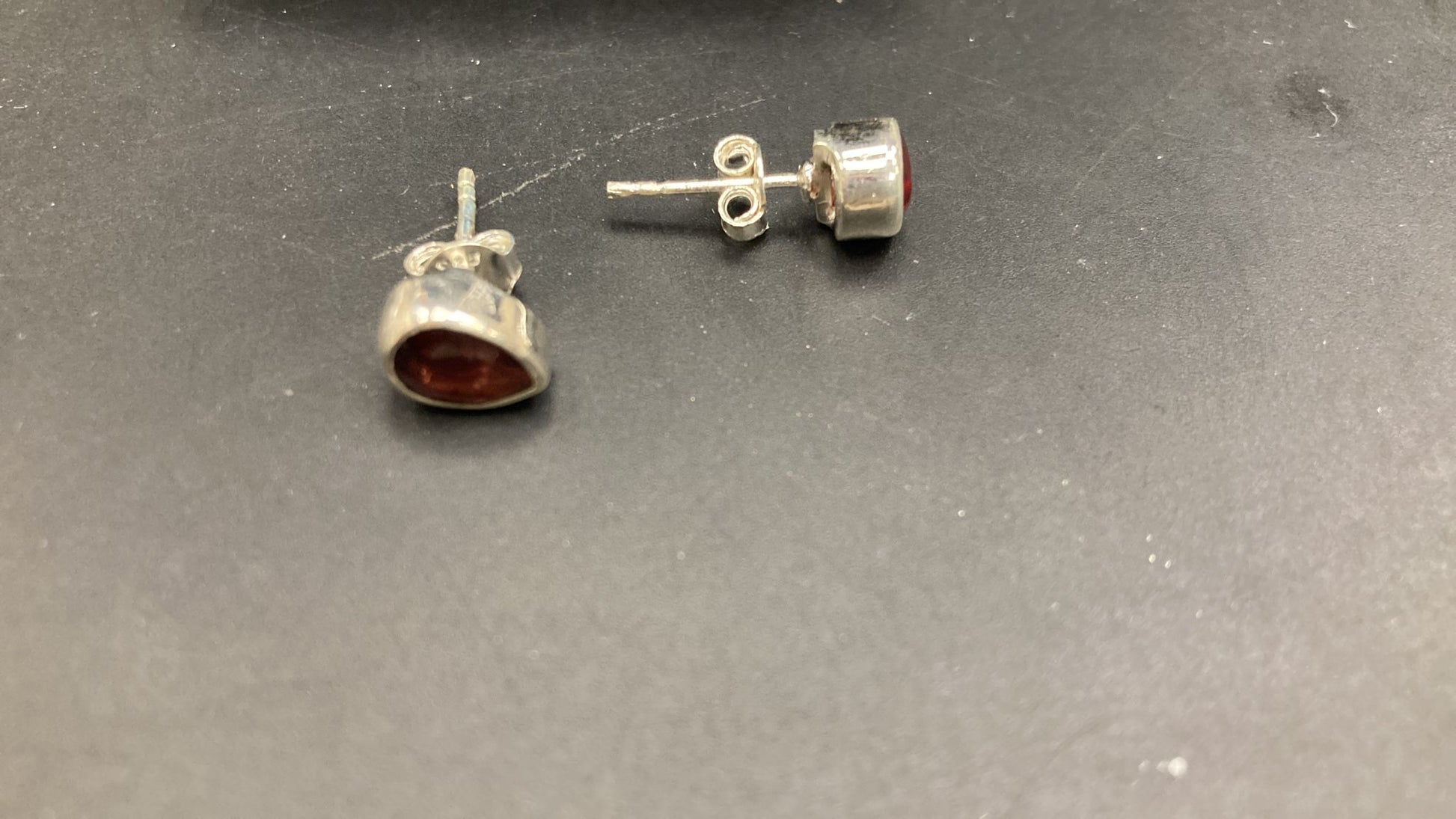 Sterling Silver Garnet Stone Stud earrings viewed from the side showcasing the garnet stone design.