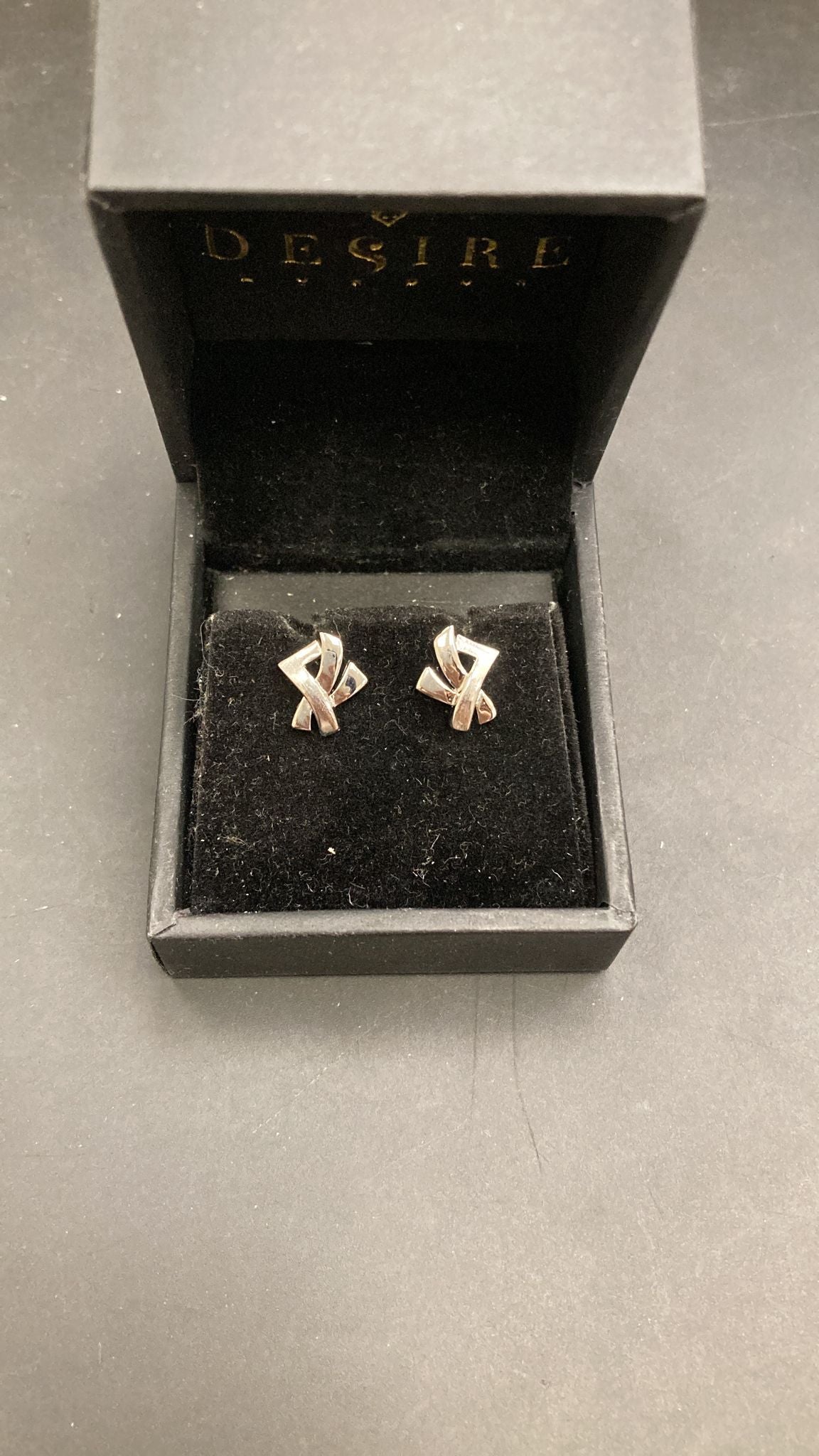 Sterling Silver X Stud Earrings ECZ017 displayed in a black jewelry box, focusing on sterling silver stud earrings.