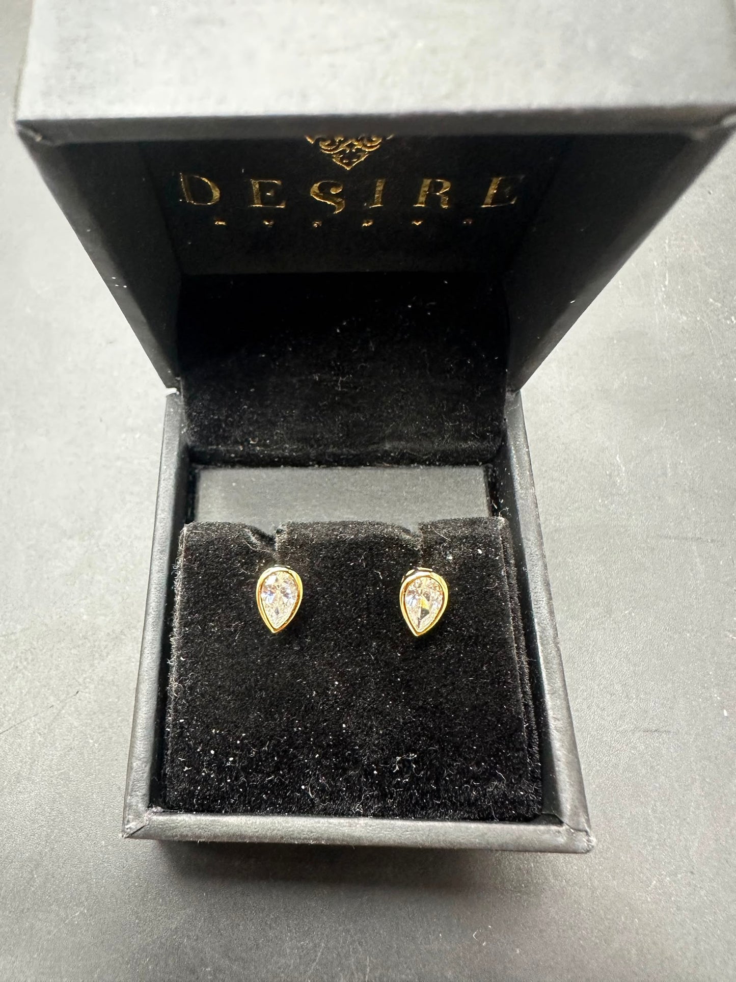 Sterling silver pear cut stud earrings with gold plated finish in elegant Desire box.