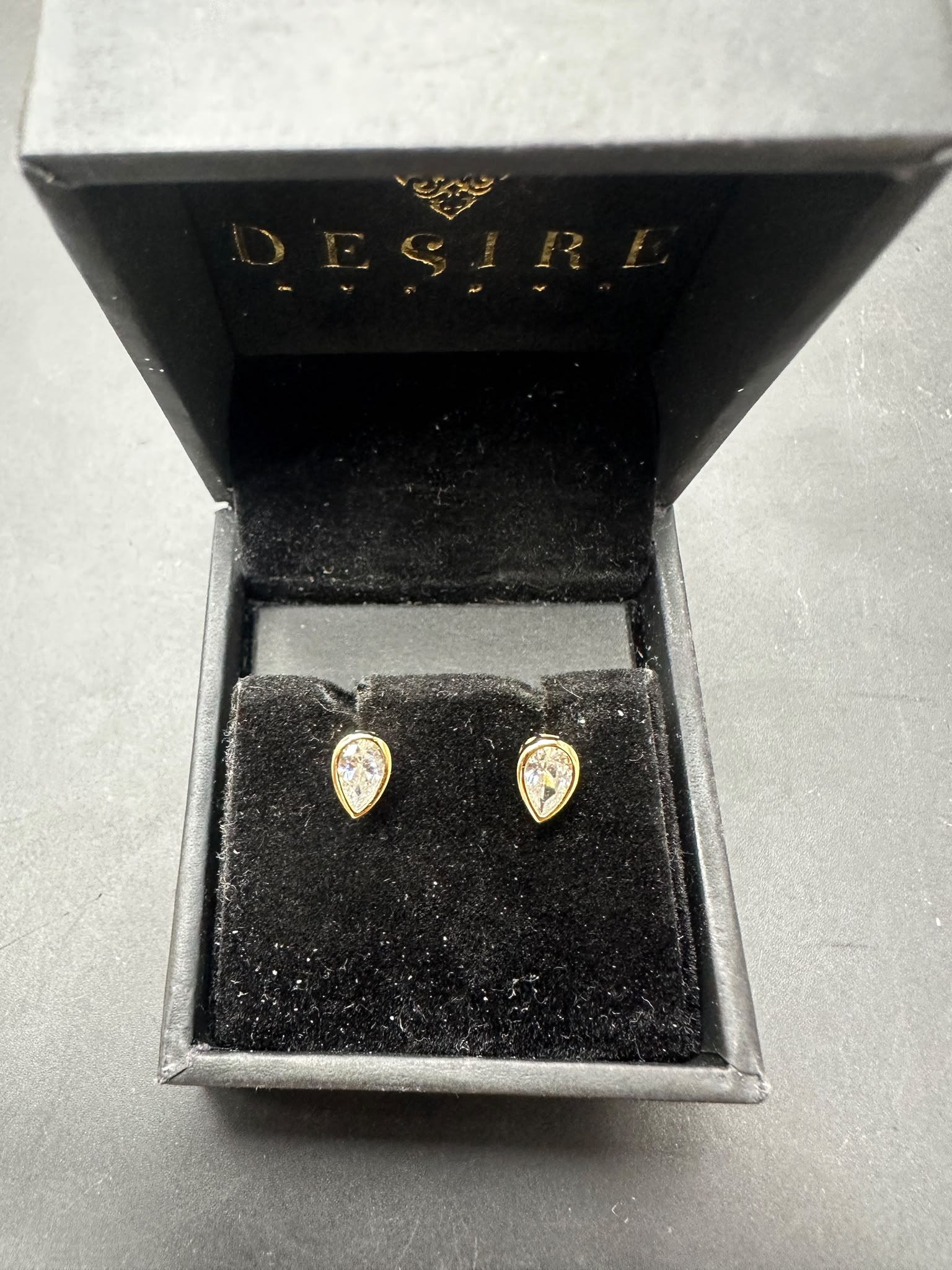 Sterling silver pear cut stud earrings with gold plated finish in elegant Desire box.