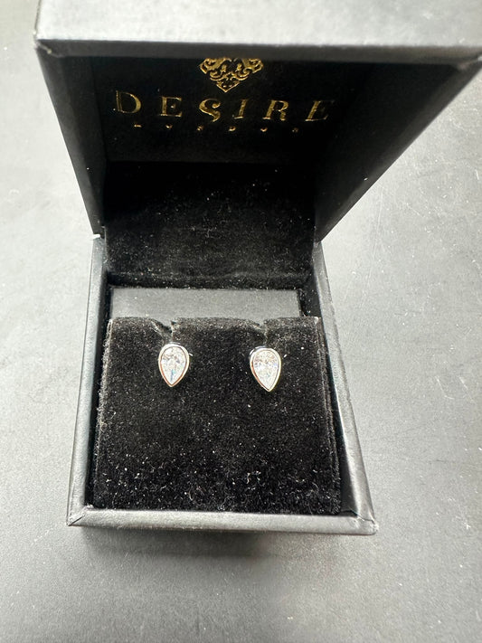 Sterling silver pear cut stud earrings featuring cz stones displayed in a black Desire jewelry box.