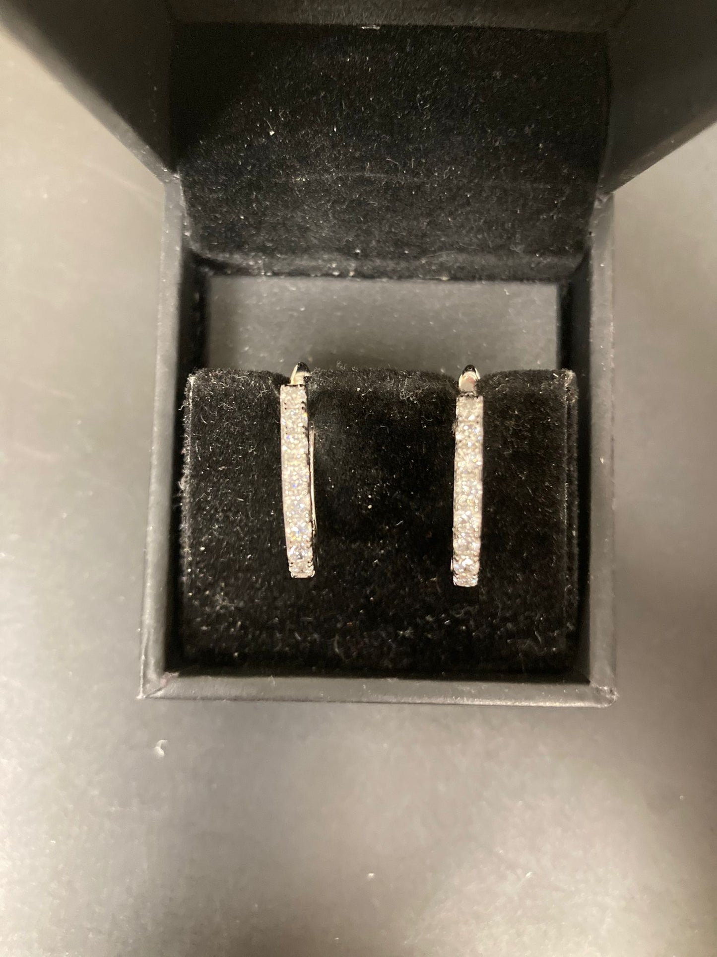 Sterling silver cz earrings ECZ10051 displayed in a jewelry box with a black velvet lining.