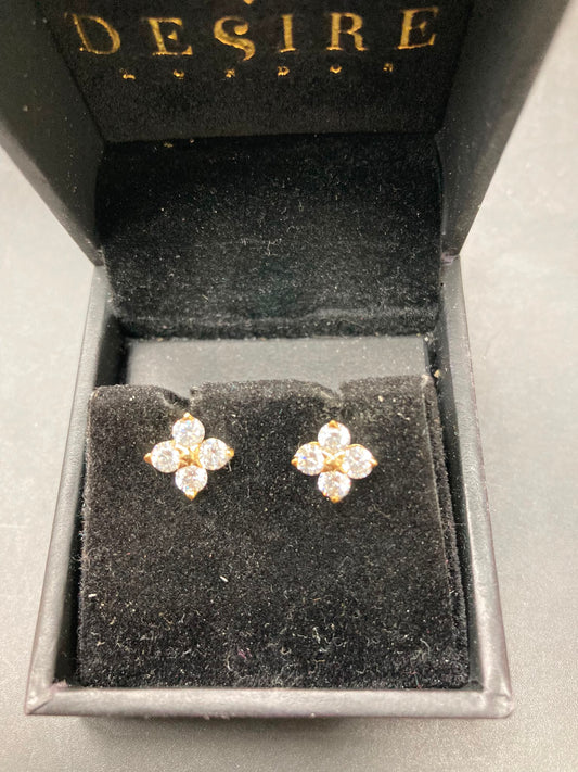 Sterling silver cz studs in a gold plated setting, featuring round 3.0mm stones displayed in a jewelry box.