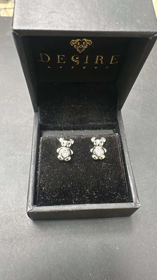 Sterling silver bear studs with CZ stone displayed in a black jewelry box.
