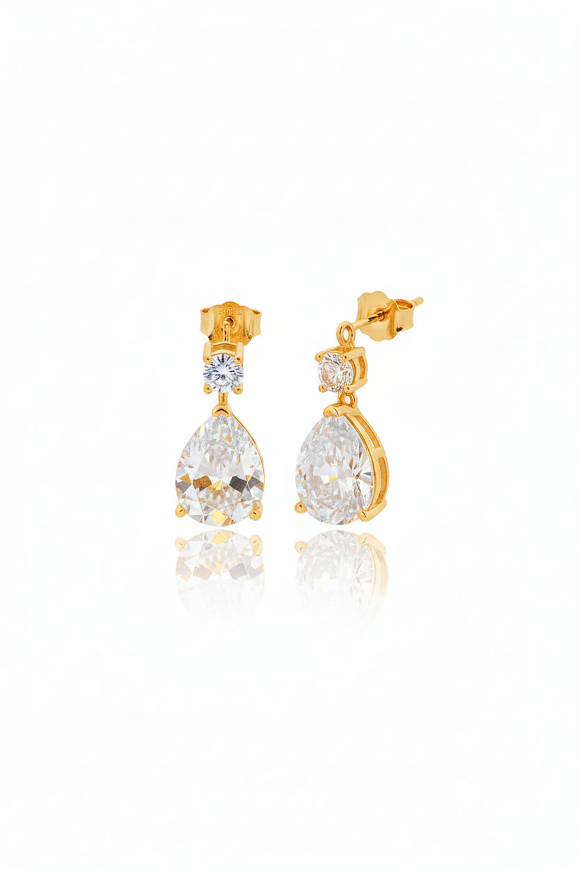 Sterling silver pear drop earrings with gold plated finish and CZ stones, featuring pear and round shapes.