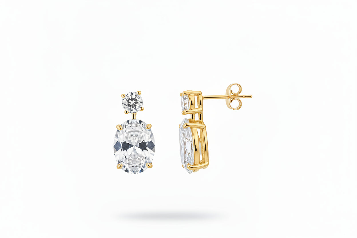 Sterling silver oval drop earrings with cz stone, featuring gold plating and round cz stones, elegant jewelry piece.