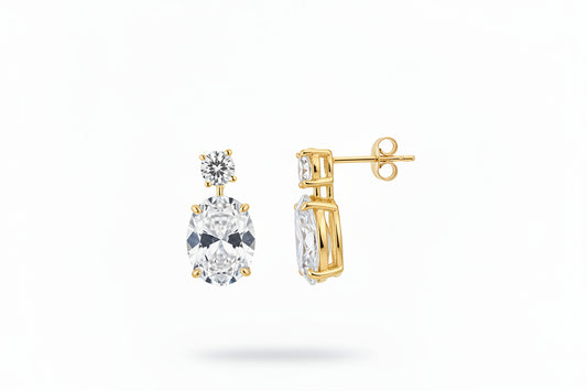 Sterling silver oval drop earrings with cz stone, featuring gold plating and round cz stones, elegant jewelry piece.