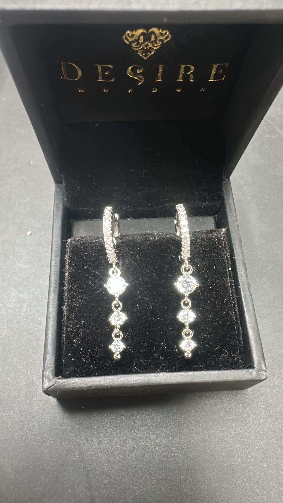 Sterling silver drop earrings cz stone presented in a luxurious box, featuring sparkling cubic zirconia stones.