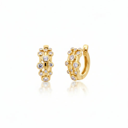 Sterling silver huggie earrings with gold plating and sparkling CZ stones for a chic look.