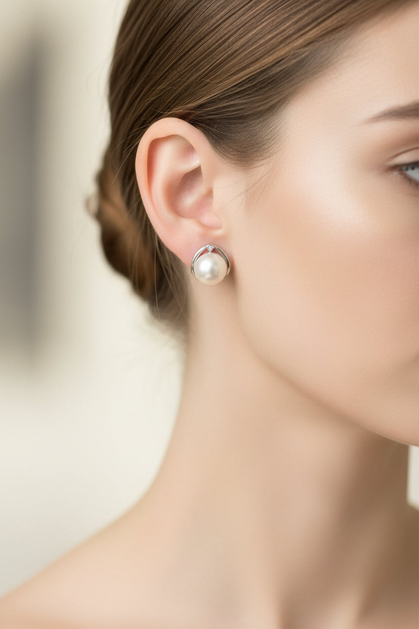 Sterling Silver Cz Pearl Stud ECZ6108 worn as sterling silver pearl stud earrings on model's ear.