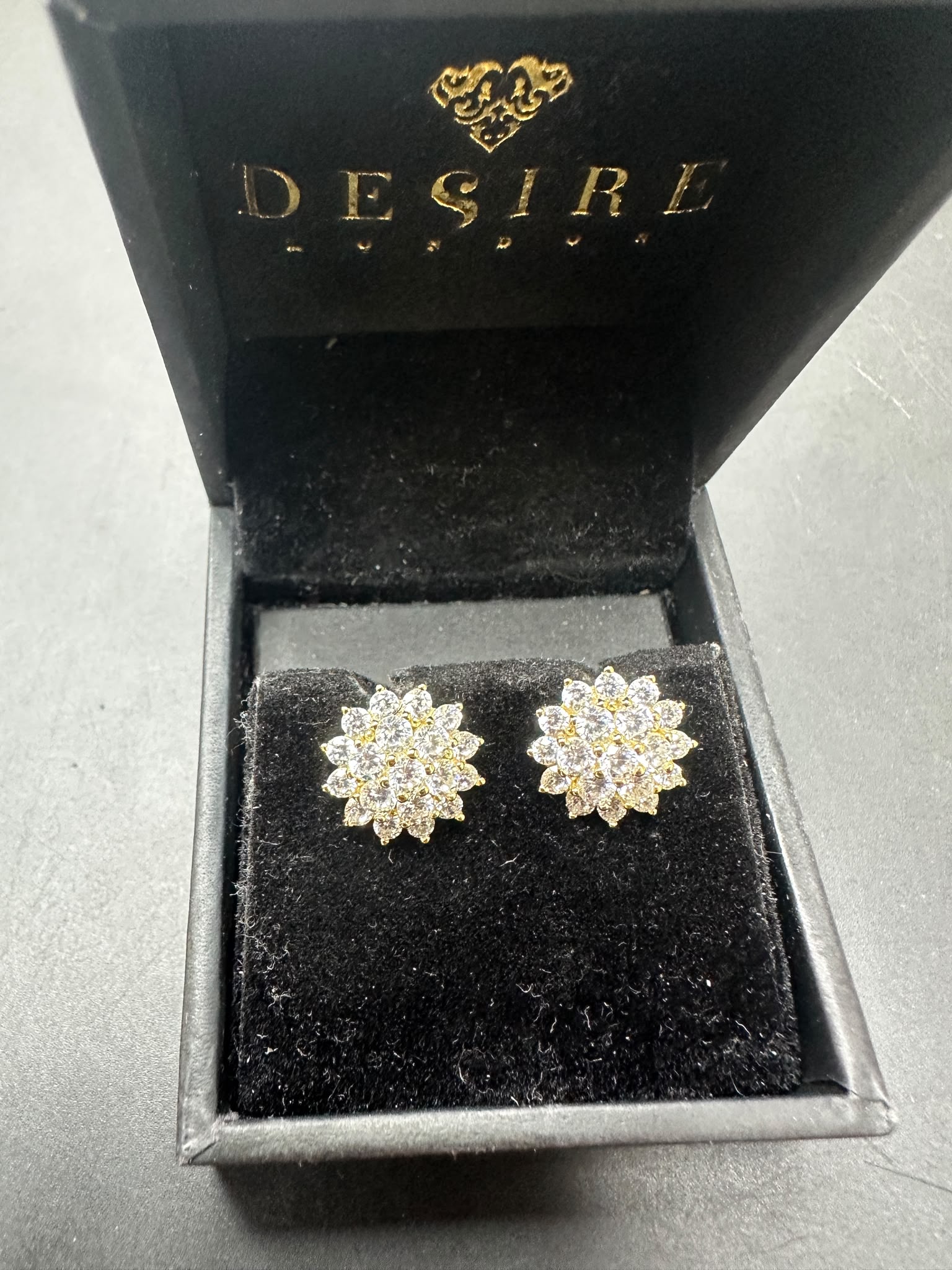 Sterling silver studs with cz stone in gold plated floral design, presented in Desire London gift box.