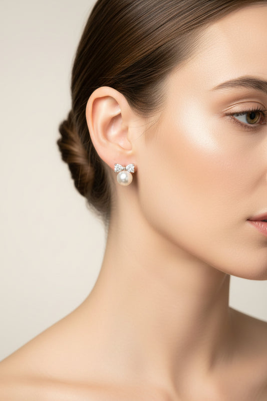 Close-up of a model wearing sterling silver cz bow pearl studs, showcasing elegance and sophistication.