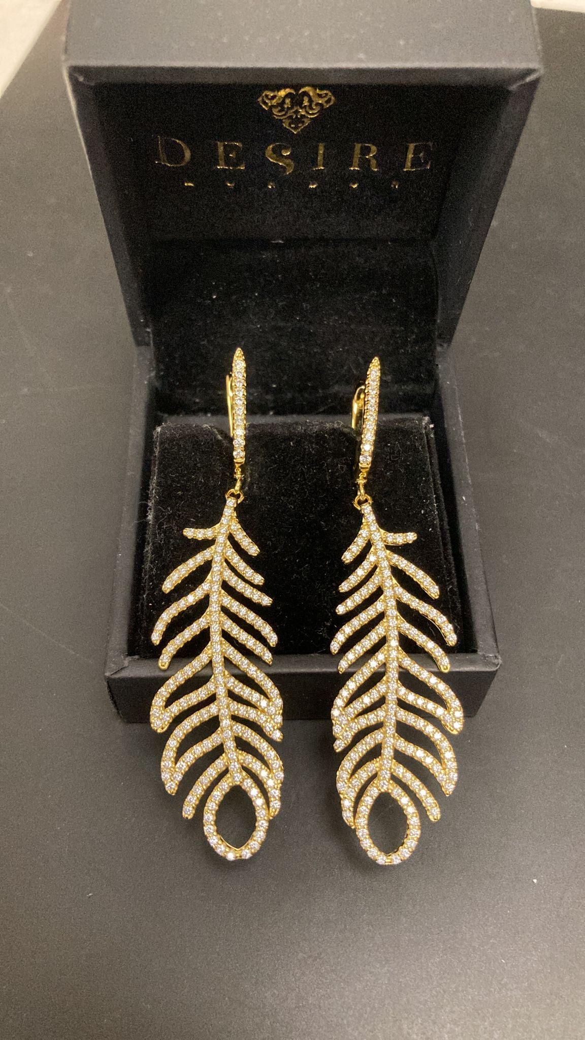 Sterling Silver Feather Dangle Earrings ECZ917 in a black box, showcasing intricate design of sterling silver feather earrings.