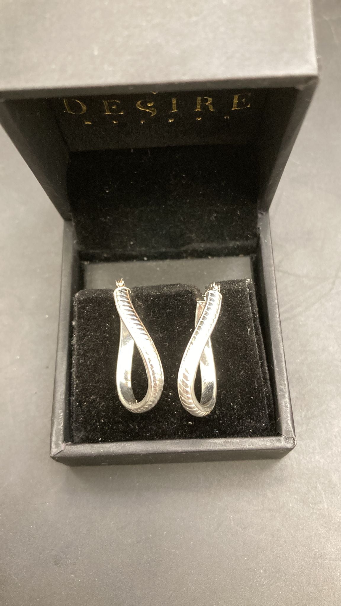 Sterling Silver Twisted Earring EP0007 displayed in a black jewelry box with a luxurious feel.