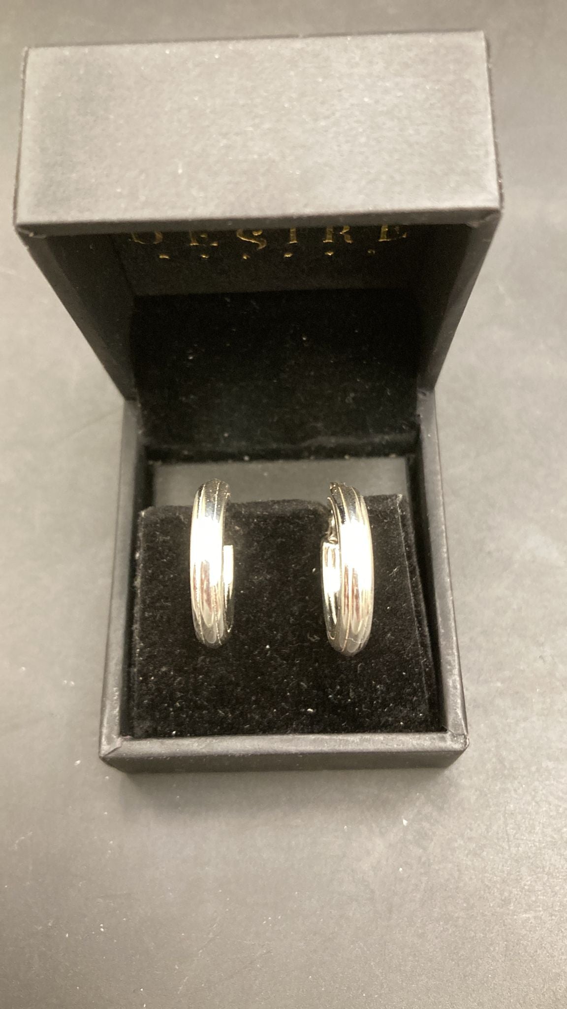 Sterling Silver Hoop Earrings EP100116 displayed in a black jewelry box with velvet interior.