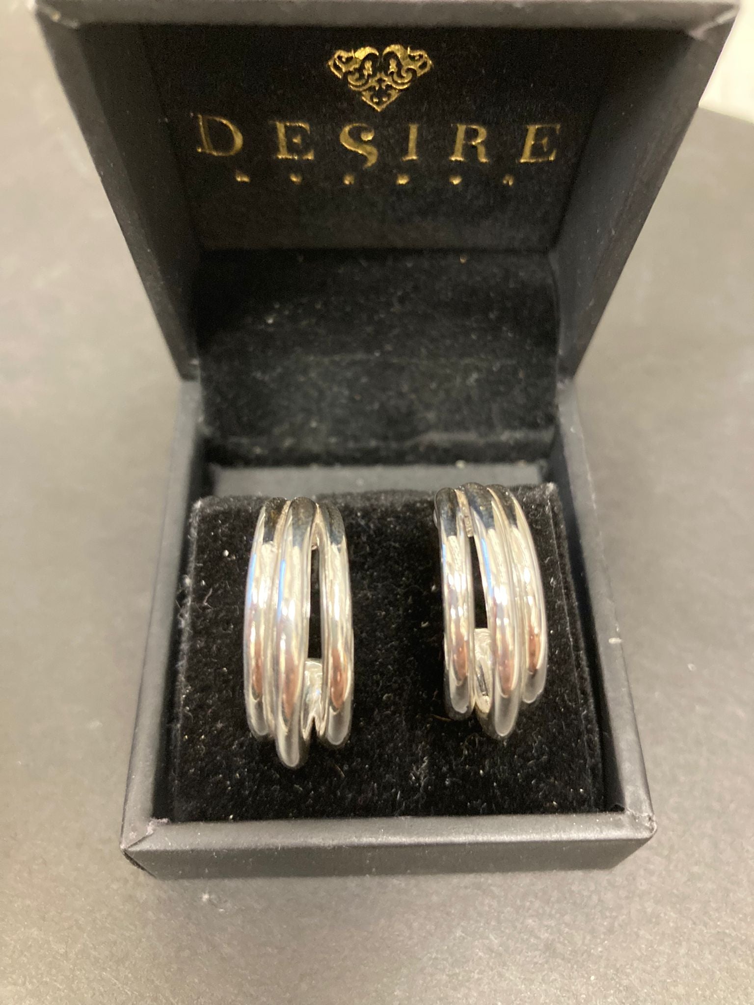 Sterling Silver Triple Hoop Earrings EP100119S displayed in a jewelry box.