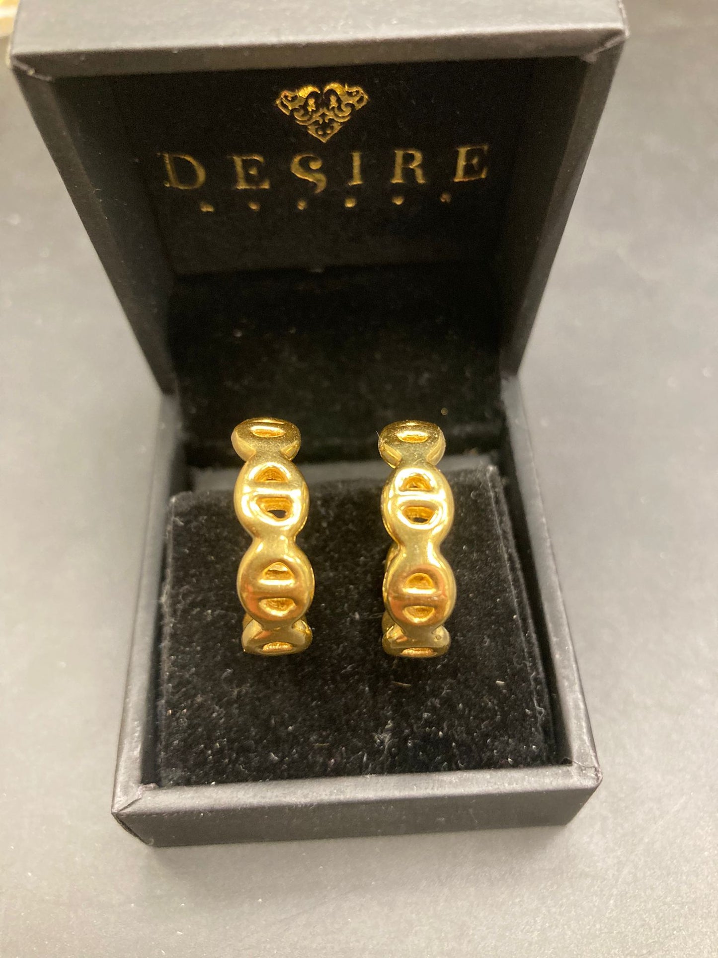 Gold plated chain link earrings in elegant box, showcasing their unique design and luxurious finish.