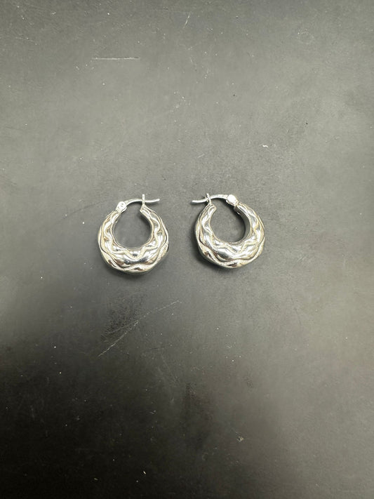 Sterling Silver Creole Hoop Earrings EP102457 displayed on a dark background, showcasing their unique design.