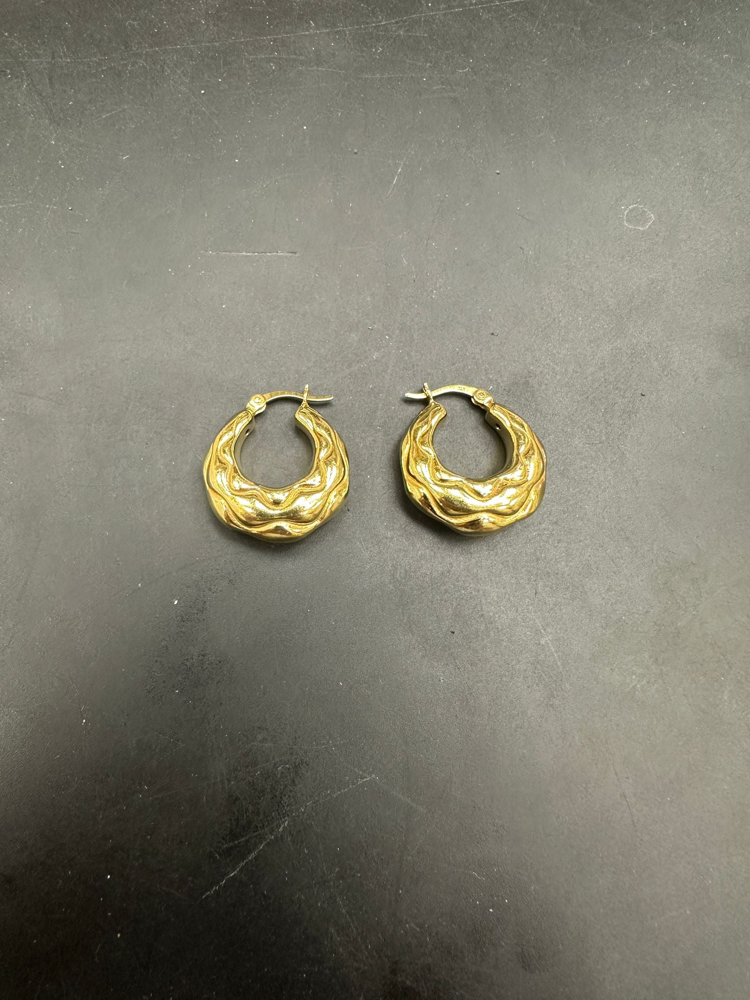 Sterling Silver Creole Hoop Earrings EP102457 displayed on a dark background, showcasing unique design.