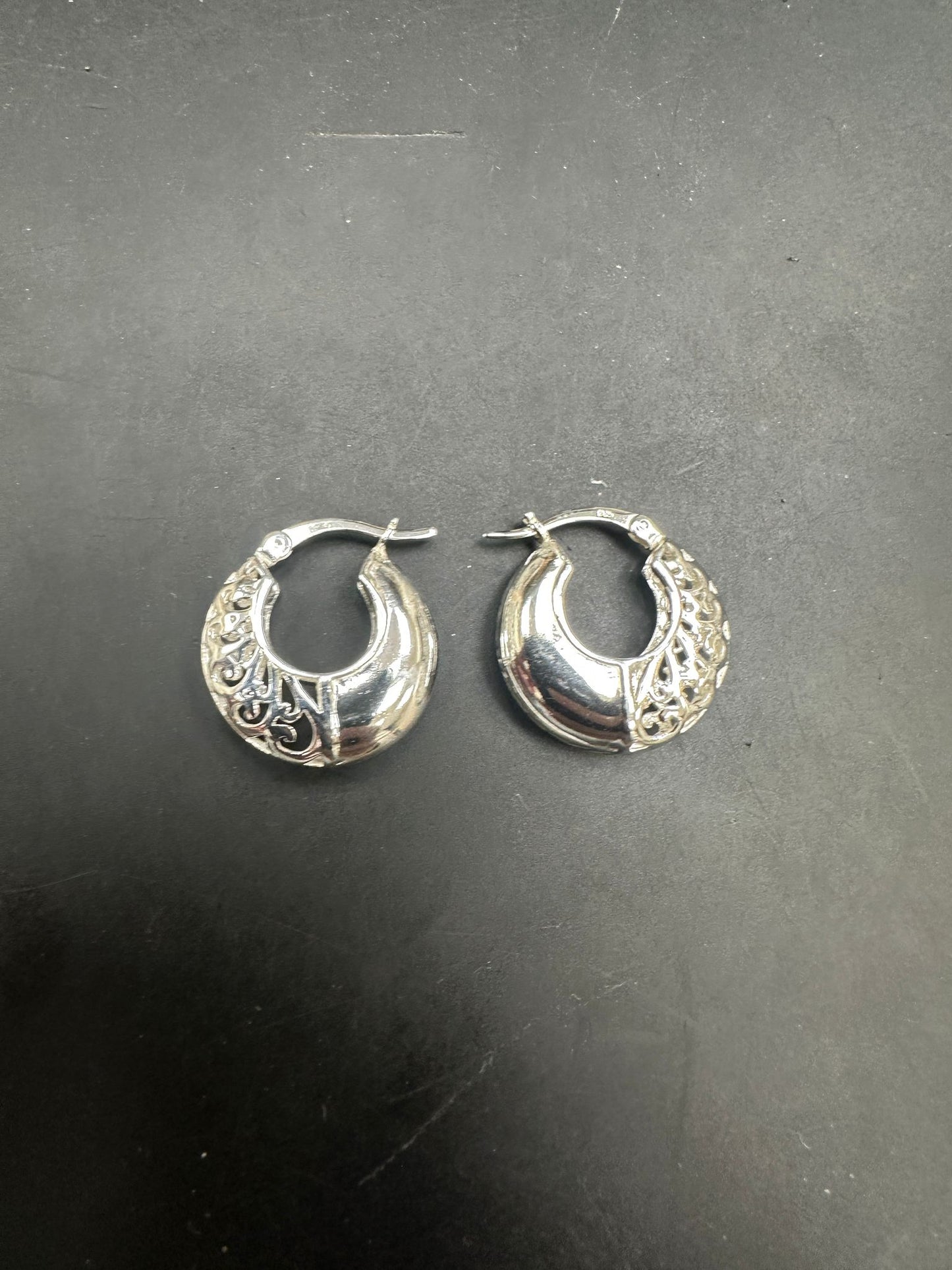 Sterling Silver Patterned Hoop Earrings EP10245 showcased on a black background, highlighting their intricate design.