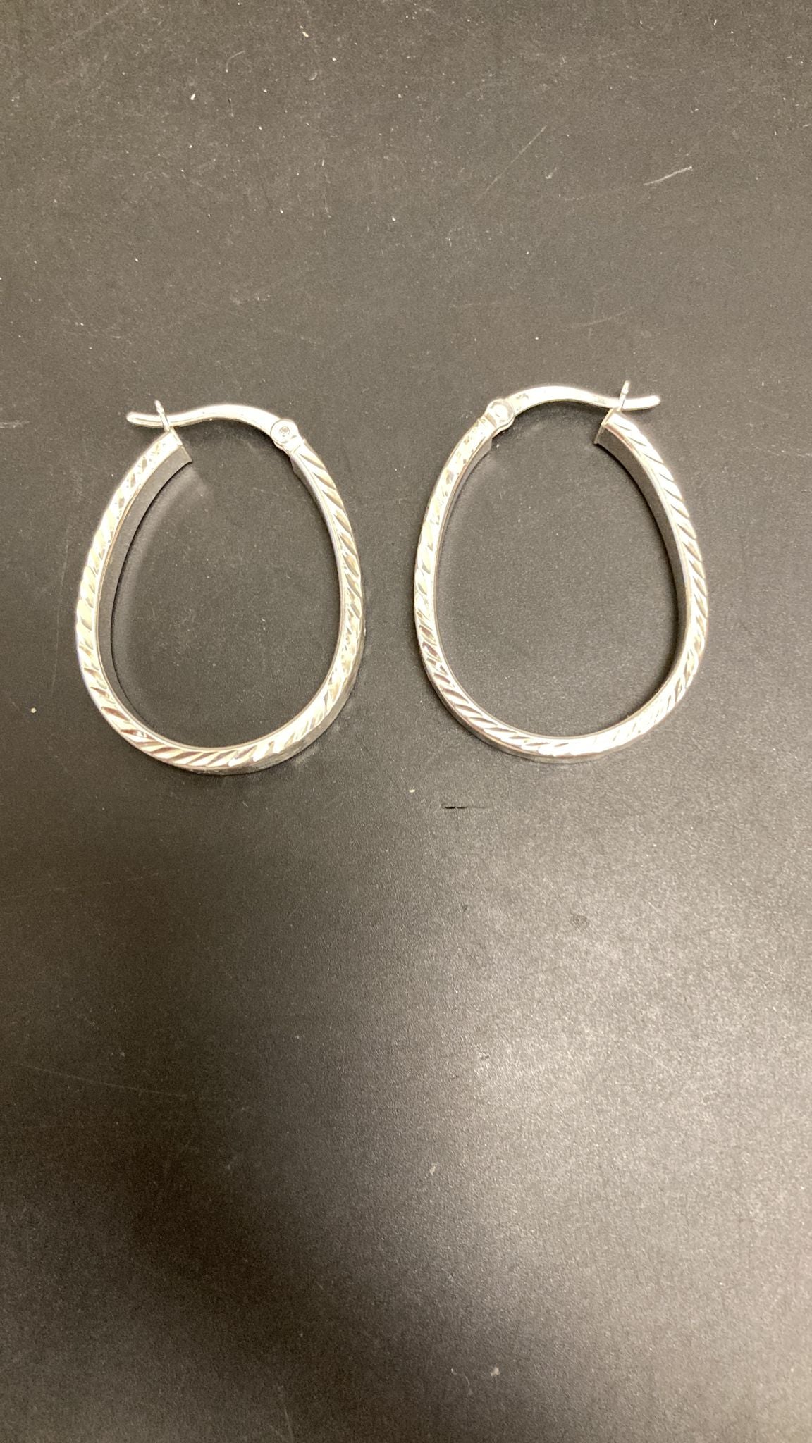 Sterling silver hop earrings in a beautiful hoop design, showcasing intricate detailing and elegance.