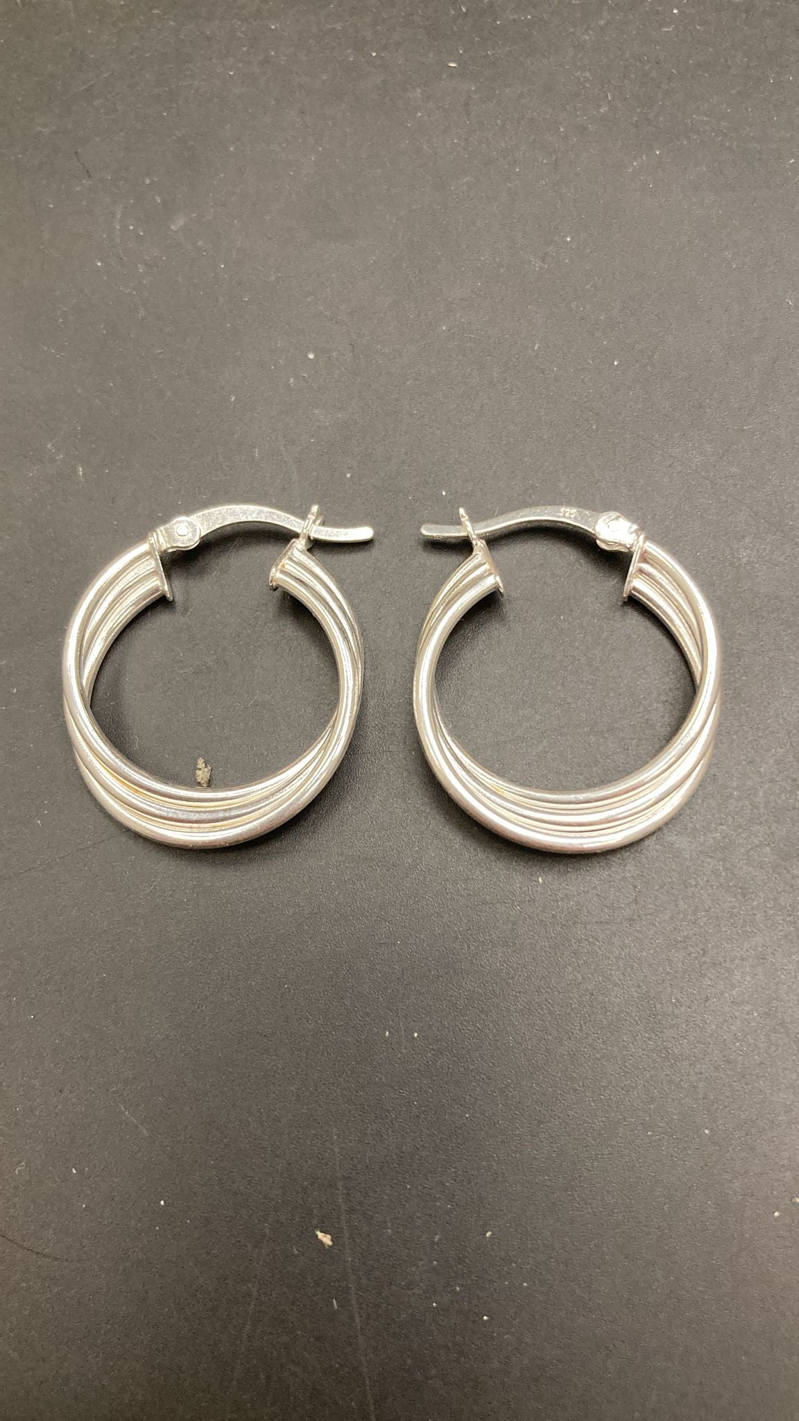 Sterling silver huggies earrings featuring a stylish patterned design, ideal for everyday wear.