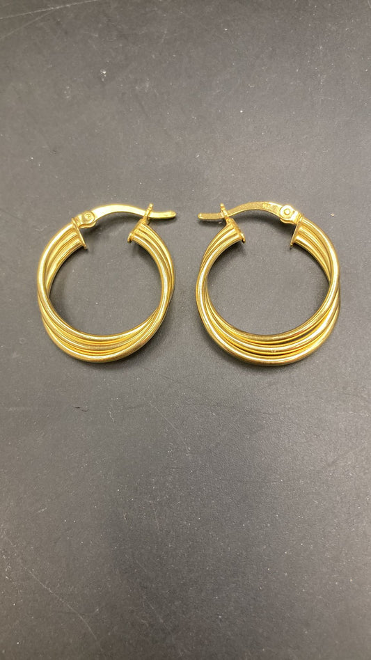A pair of elegant sterling silver huggies earrings with a unique pattern design.