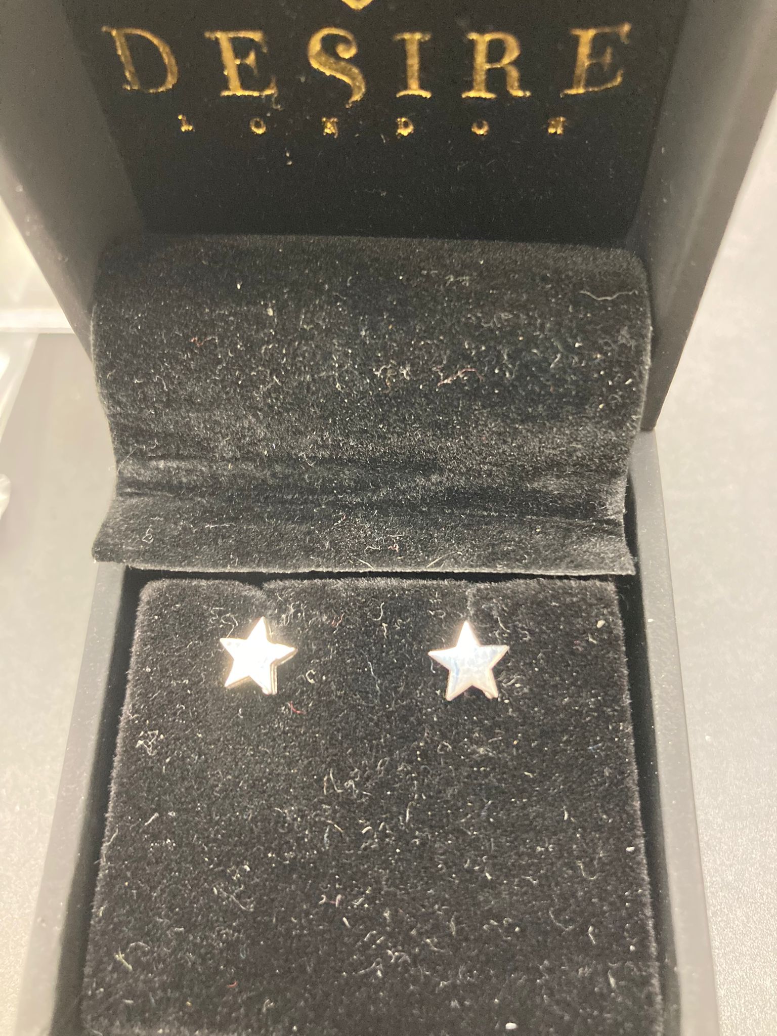 Sterling Silver Plain Star Stud Earrings EP9101 displayed in packaging with a velvet interior.