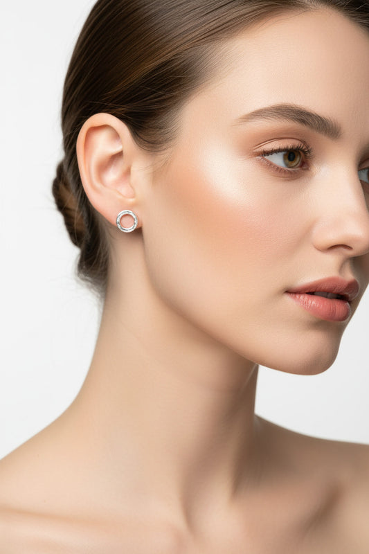 Silver earrings in a black jewelry box with 'DESIRE' branding.